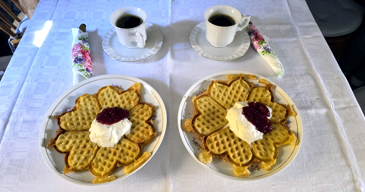 Coffee and and freshly baked waffles with jam and cream served in the former office in Hökeriet in Lund